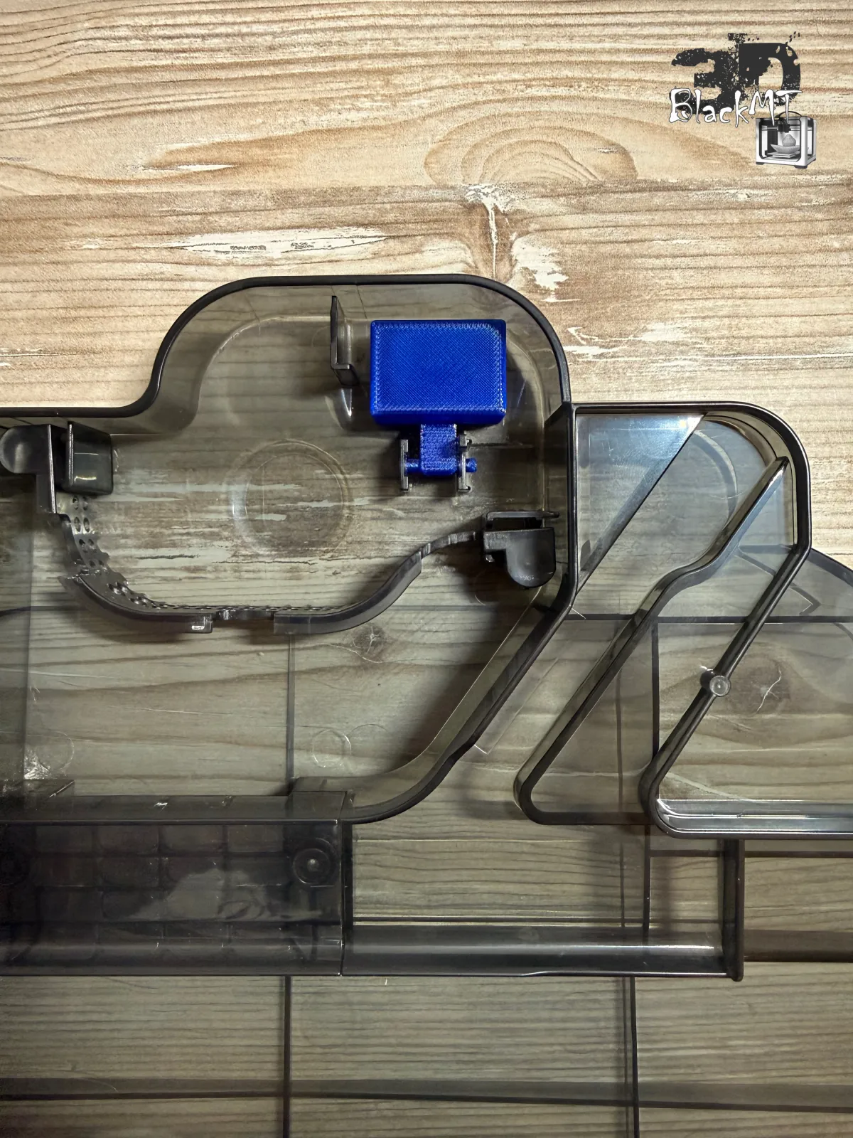 Blue replacement float fitted in its mounting position in the water tray of the Ecovacs Deebot X9